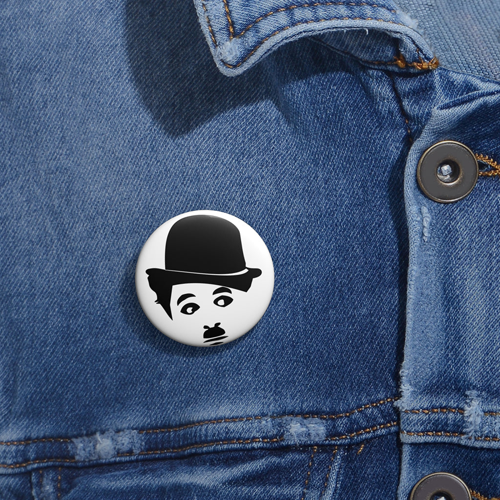 1.25 inch pin featuring black-and-white Charlie Chaplin face – silent film burnout button by NOPE & CO. on a denim jacket