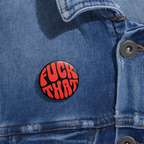 Denim jacket with a round pinback button with bold red “F*ck That” text on black background.