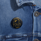 Denim jacket with a glossy black pinback button with gold outline of angry dog giving double middle fingers and text “FETCH THIS.”